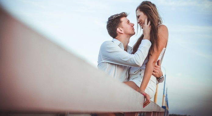 couple hugging each other on pier