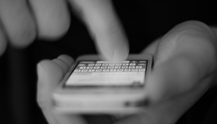 man texting on iphone