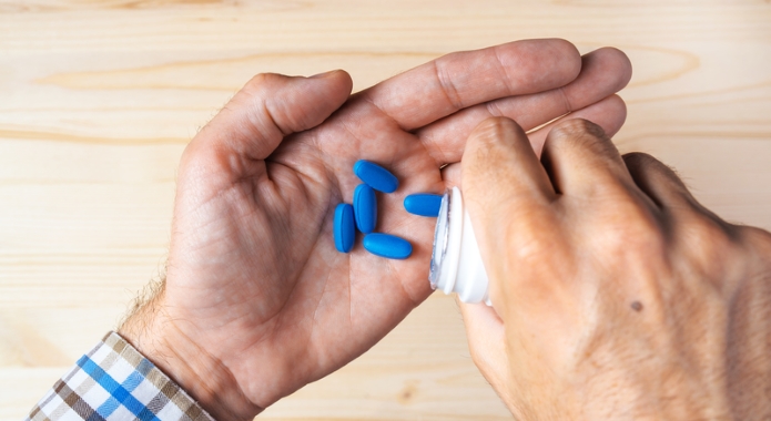 man holding male enhancement pills